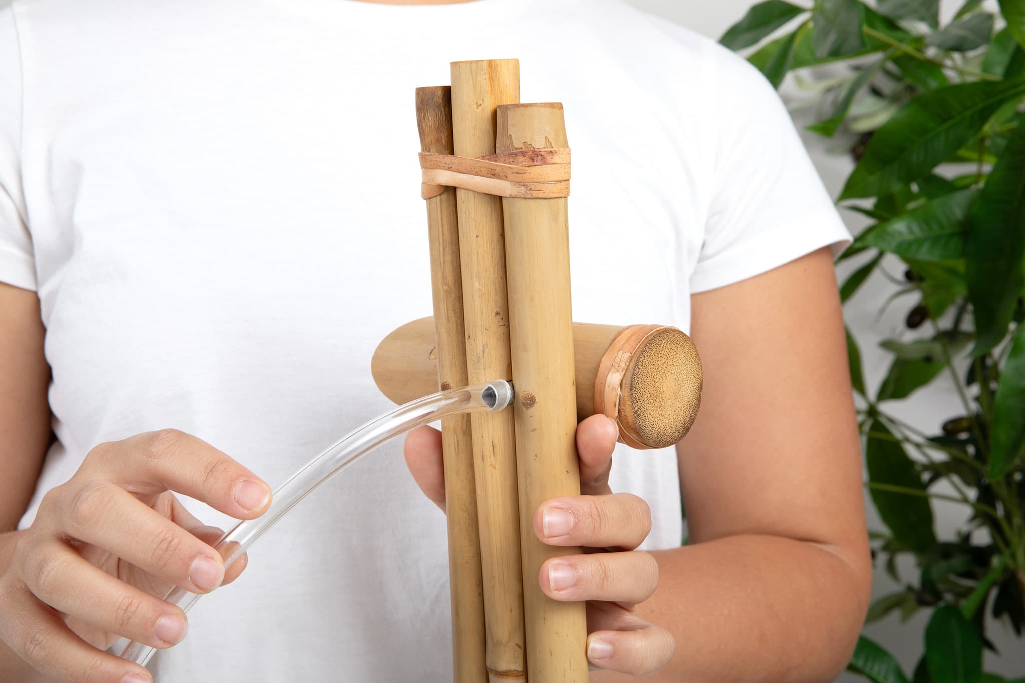 Hands holding bamboo fountain showing craftsmanship details